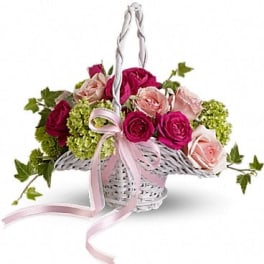 Basket of pink and red roses with green hydrangeas and a pink ribbon