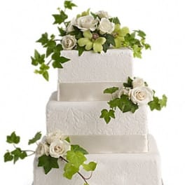 Four-tier white cake with white roses and ivy