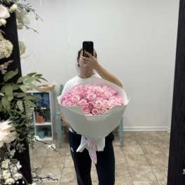 Large bouquet of pink roses wrapped in white paper