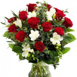 Bouquet of red roses and white orchids in a glass vase