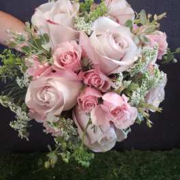 Pink rose bouquet with white filler flowers and greenery