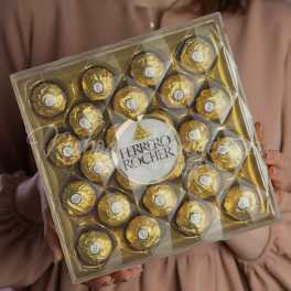 Box of Ferrero Rocher chocolates held in both hands