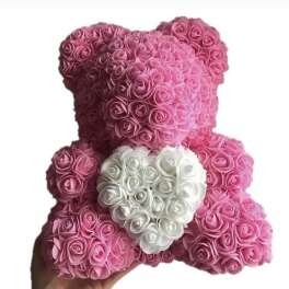 Pink rose teddy bear with a white heart on its chest