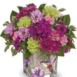 Pink and green mixed flower arrangement in a decorated glass vase
