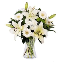 White lily and daisy bouquet in a clear glass vase