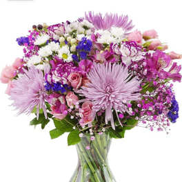 Pink and purple mixed bouquet in a clear glass vase
