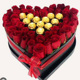 Heart-shaped box of red roses with gold-wrapped chocolates