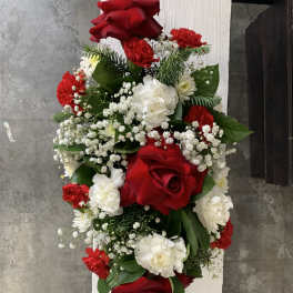 Red and white floral arrangement with roses, carnations, and baby's breath