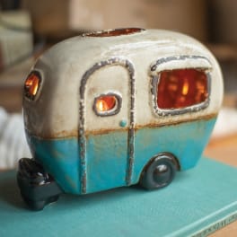 Ceramic camper-shaped candle holder with glowing openings