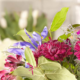 Bouquet of purple and pink flowers with green leaves