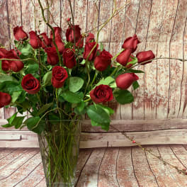 Red roses arranged in a clear glass vase