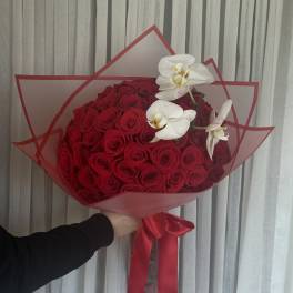 Large bouquet of red roses with white orchids wrapped in red paper