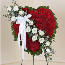 Heart-shaped red floral standing spray with white roses and ribbon