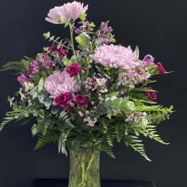 Pink and magenta mixed bouquet in a clear glass vase