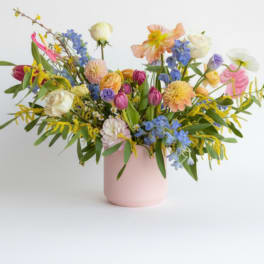 Colorful mixed bouquet in a pink vase