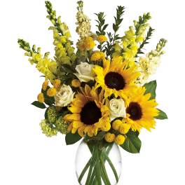 Sunflowers and white roses in a clear glass vase