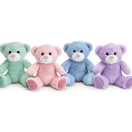 Four pastel teddy bears sitting in a row