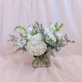 White floral arrangement in a clear glass vase