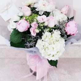 Pink and white bouquet with ribbon in a box