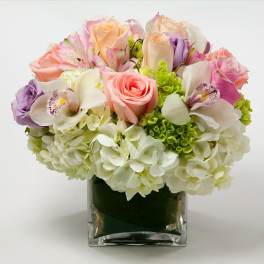 Mixed pastel bouquet in a square glass vase