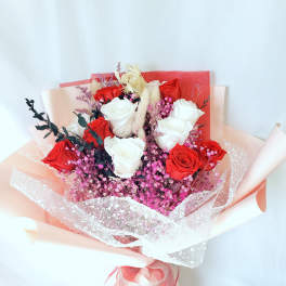 Bouquet of red and white roses with pink filler flowers