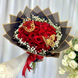 Bouquet of red roses with baby's breath and decorative butterfly accents