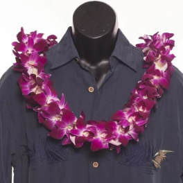 Purple orchid lei draped over a dark shirt on a mannequin