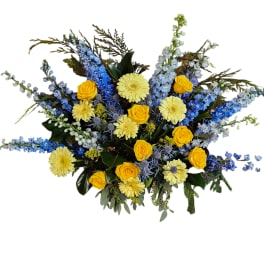 Bouquet of yellow roses, pale gerberas, and blue flowers