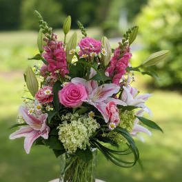 Pink and white floral arrangement in a clear glass vase