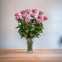 Pink roses arranged in a clear glass vase