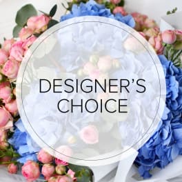 Mixed bouquet of blue and pink flowers with a designer's choice label