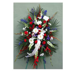 Standing funeral spray with red, white, and blue flowers