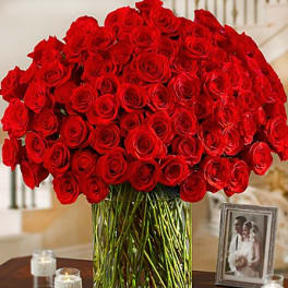 Large bouquet of red roses in a clear glass vase