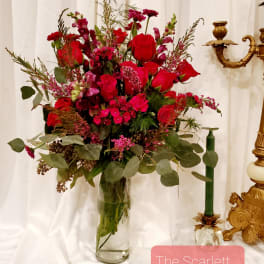 Red floral arrangement in a clear glass vase