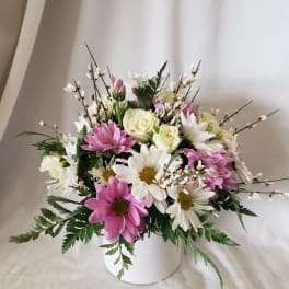 Pink and white daisy bouquet in a white vase