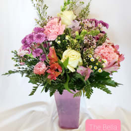 Mixed pink and white bouquet in a purple vase