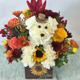 Dog-shaped floral arrangement in a wooden box with a tiny hat
