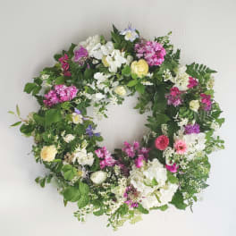 Circular floral wreath with white, pink, and yellow blooms