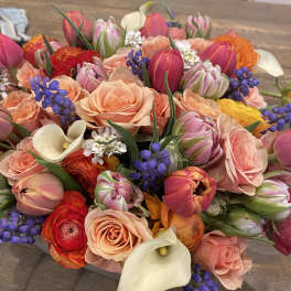 Mixed bouquet of pink roses, tulips, calla lilies, and purple accents