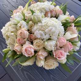 Bouquet of white hydrangeas, pale pink roses, and white tulips