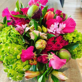 Bright bouquet of pink flowers with green hydrangeas and mixed blooms