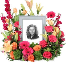 Floral photo frame arrangement with pink and orange flowers