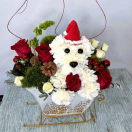 White teddy bear floral arrangement with red roses and a Santa hat
