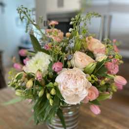 Pink and white mixed bouquet in a striped glass vase
