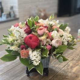 Mixed pink and white bouquet in a black container