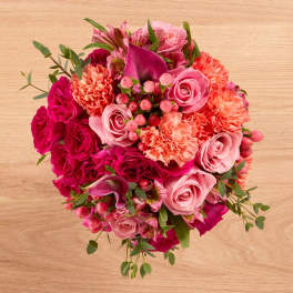 Pink and magenta bouquet with roses, carnations, and calla lilies