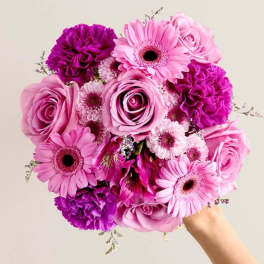Pink and purple bouquet with roses, gerbera daisies, and carnations