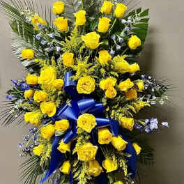 Tall yellow rose standing spray with blue ribbon and palm fronds