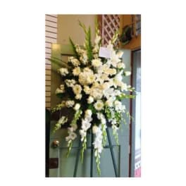 Tall white floral standing spray on an easel