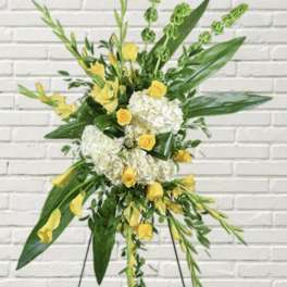 Tall floral standing spray with yellow roses and white hydrangeas